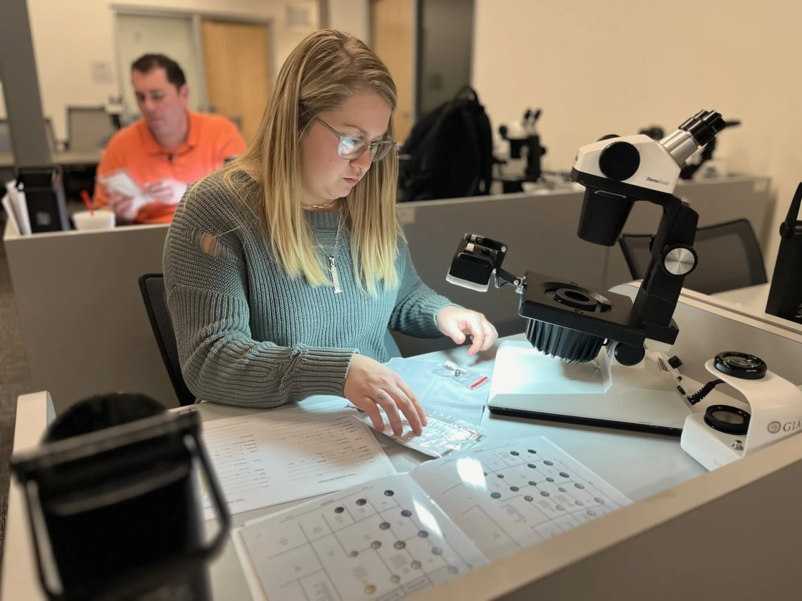 Student studying pearls gemological tools.